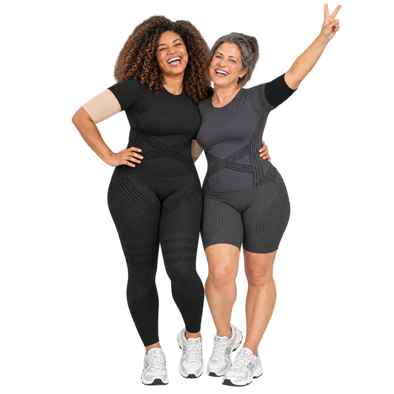 Two women wearing the 3D Complete Set, one in Full Black with nude arm sleeves, one in Full Dark Gray with black arm sleeves